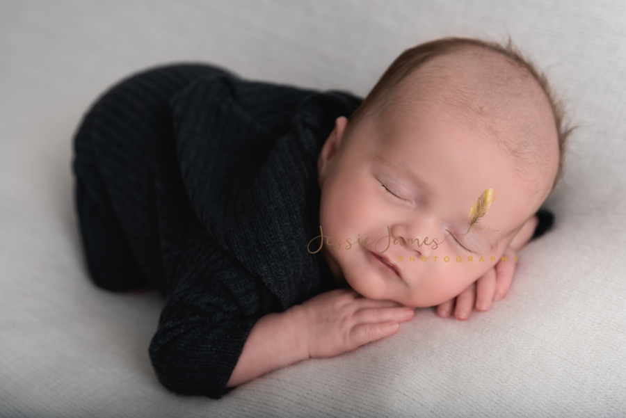 baby boy sleeping with his head on his hands, newborn baby sleeping, newborn photography pose, baby boy