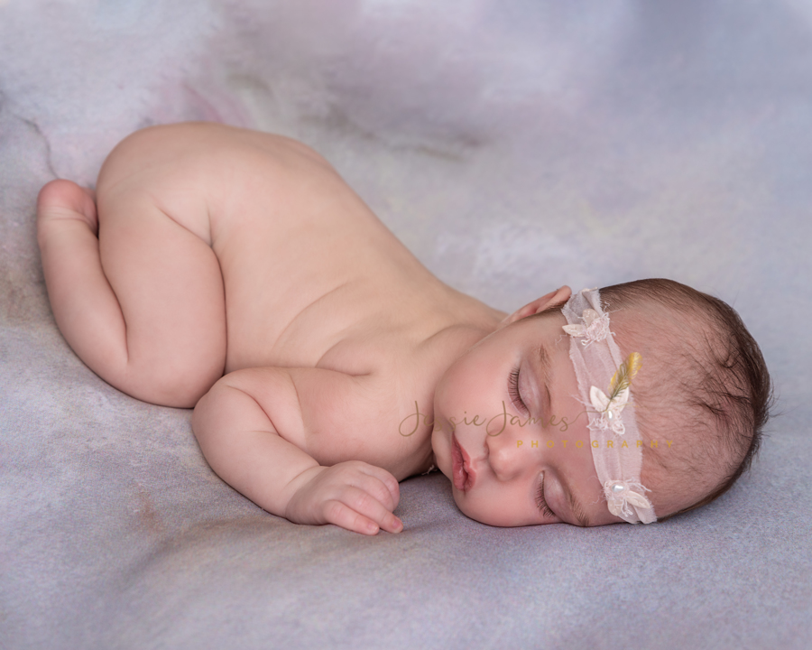 newborn baby girl photography pose, baby sleeping on her belly with bum up in the air