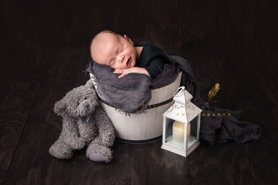 baby in a bucket, gray teddy bear, baby sleeping, baby sleeping in a bucket with gray blanket