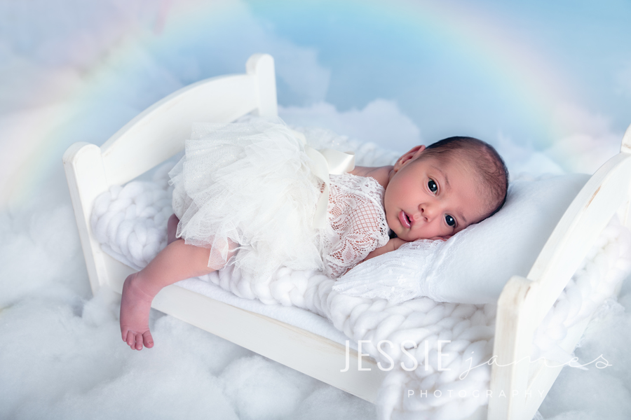 rainbow baby, baby sleeping on a bed with a rainbow backdrop, baby loss awareness