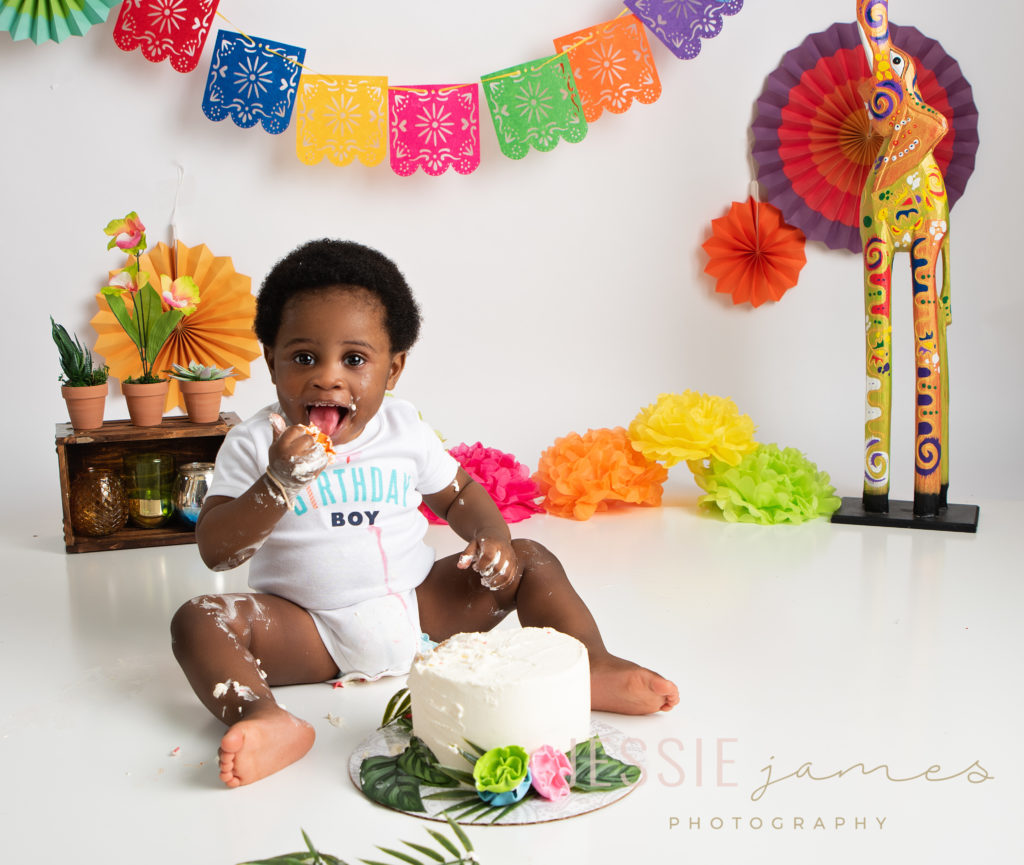 One year old boy cake smash session with an African themed set. First birthday portraits