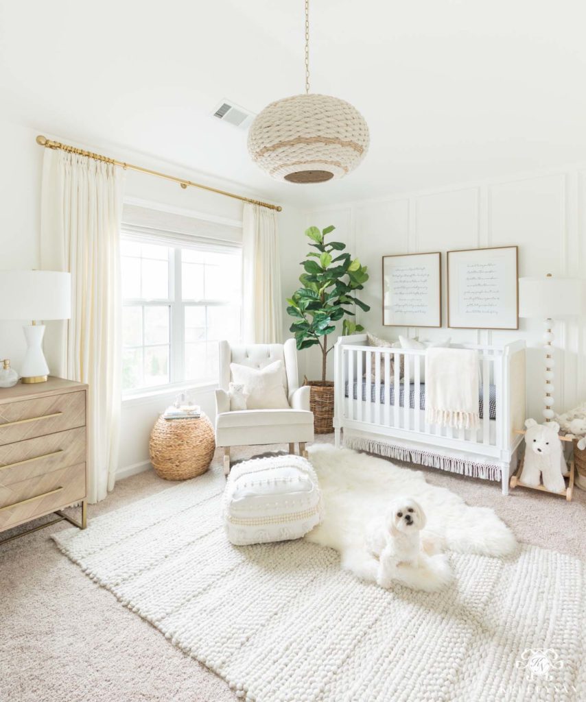 Gender neutral nursery.  Nursery has neutral colors and pops of wood accent decor, which is a top nursery trend for 2020.