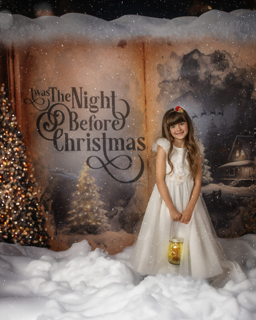 little girl dressed in holiday wardrobe in front of a giant page of a storybook
