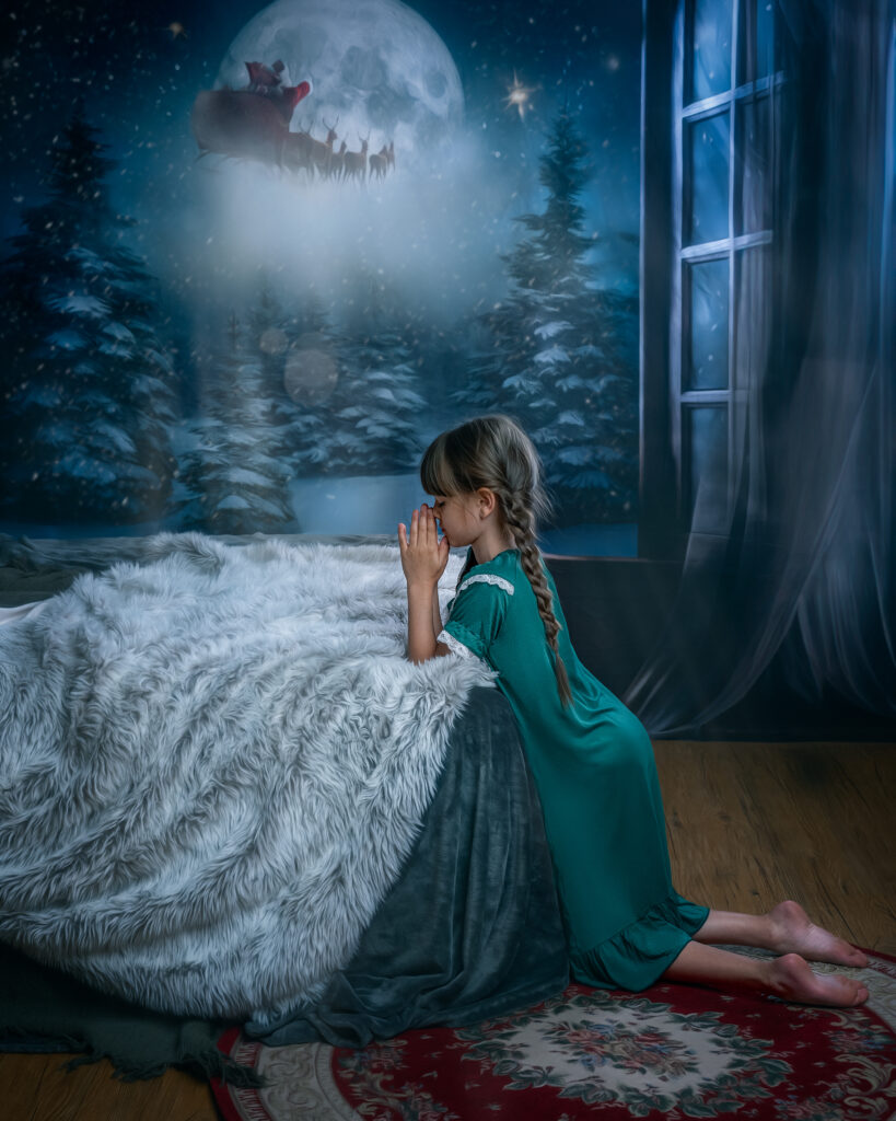 little girl praying by her bed waiting for santa