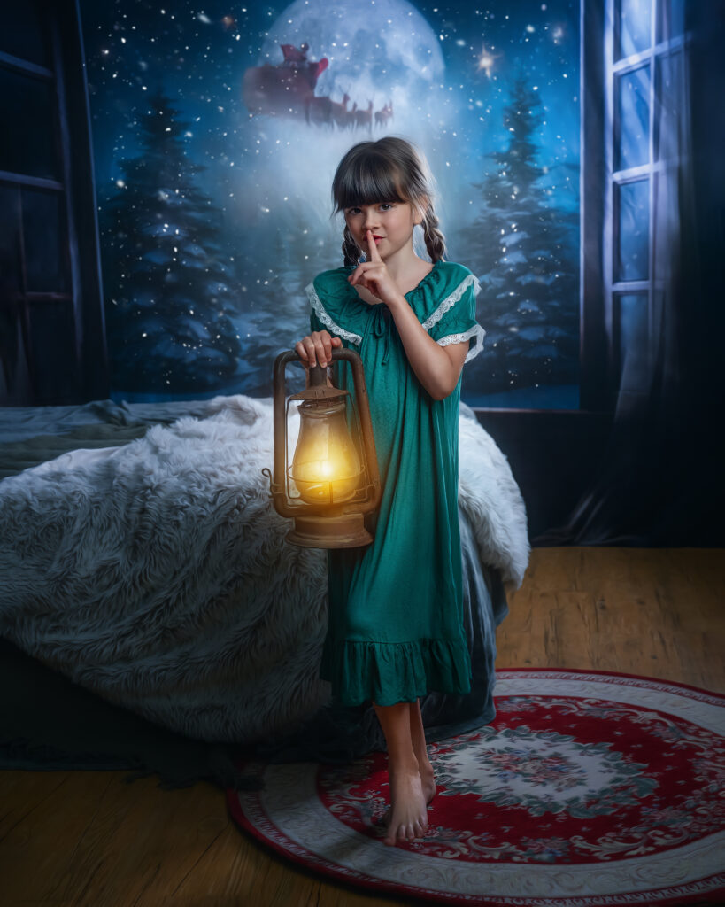 little girl in a bedtime christmas scene with santa flying outside of her window
