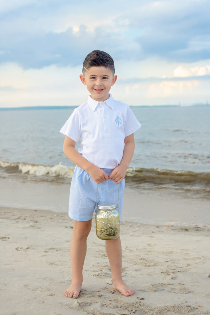 little boy at beach holding a lantern