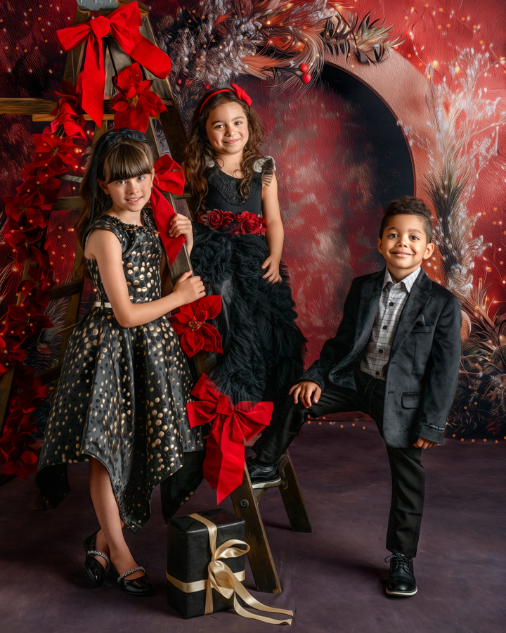 Three kids posing with a ladder in the Twilight Holiday Lights set, surrounded by twinkling lights and festive greenery