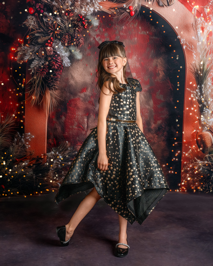 A little girl smiling and posing in the Twilight Holiday Lights set, surrounded by twinkling lights and festive greenery.