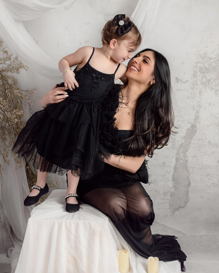 A mother and her young daughter share a nose-to-nose moment in an editorial-style fine-art motherhood portrait. The soft lighting and timeless styling make this a standout image from a luxury family photography session in Staten Island