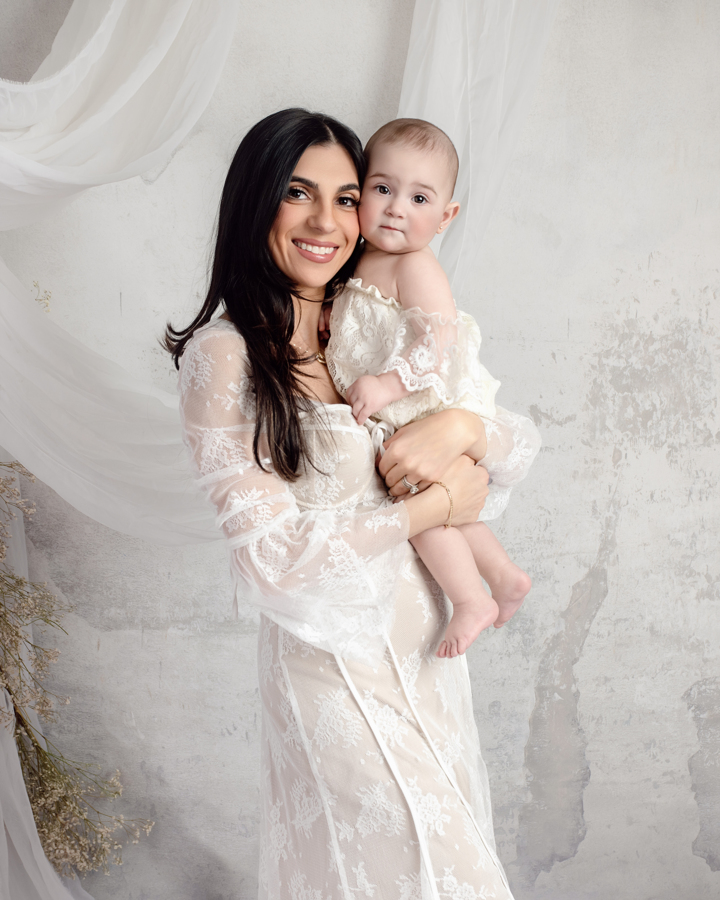 A mother lovingly cradles her baby in a dreamy, editorial-style portrait. This luxury family photography session in New Jersey highlights the beauty of motherhood with soft, natural tones.