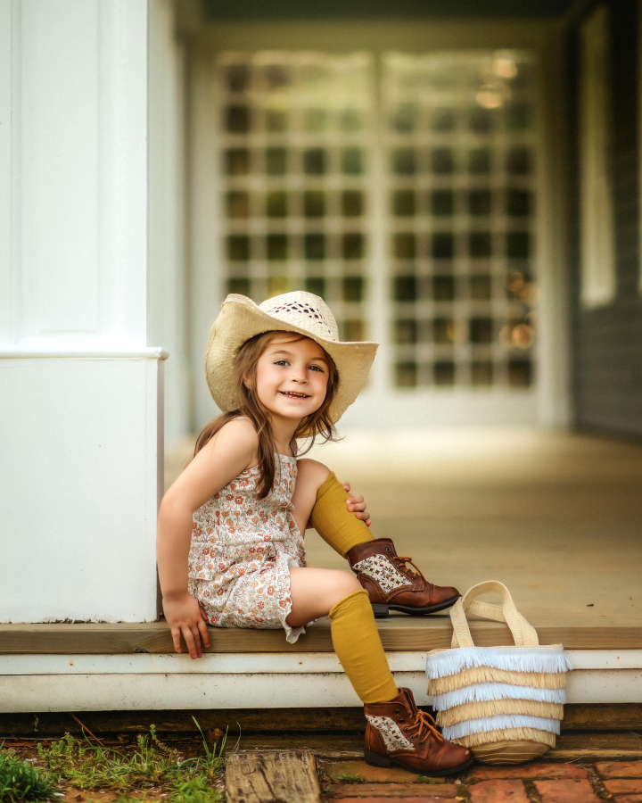 (Girl sitting on porch in cowboy hat and boots — barn setting)
Keyphrase: Rustic Barn Fall Mini Kids Portrait Holmdel NJ